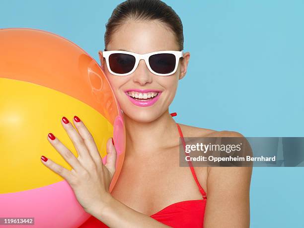 female in bikini holding beach ball - palla da spiaggia foto e immagini stock