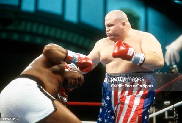 Butterbean fights Doug Phillips during a heavy weight boxing match on December 6, 1997 at the Convention Center in Atlantic City, New Jersey.