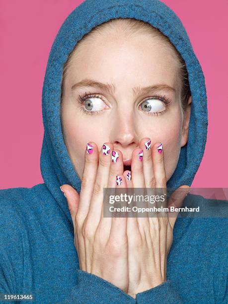 shocked young woman wearing hoody - nail art stock pictures, royalty-free photos & images