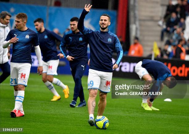 Marseille's Argentine forward Dario Benedetto greets fans ahead of the French L1 football match between Olympique de Marseille and Angers SCO at the...