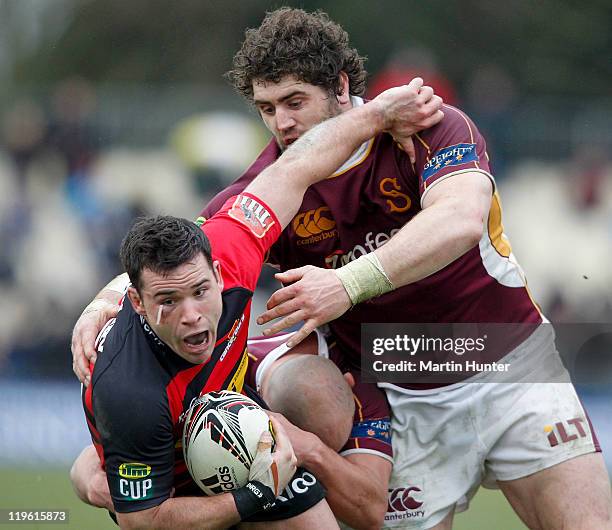 Ryan Crotty of Canterbury is tackled by Jamie Mackintosh of Southland during the round three ITM Cup match between Canterbury and Southland at AMI...