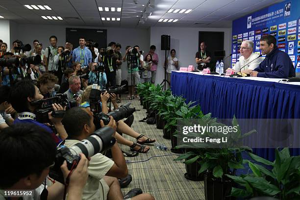 Michael Phelps and coach Eddie Reese of the United States are surrounded by media participate in a press conference on Day Eight of the 14th FINA...