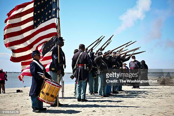 Re-enactors with the 54th Regiment Massachusetts Volunteer Infantry fire muskets during ceremonies to honor the anniversary of the historic 1863...