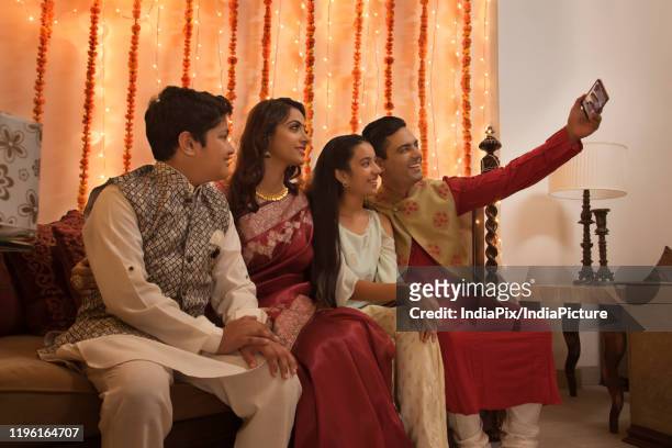 family clicking selfie together on diwali - father clicking selfie bildbanksfoton och bilder