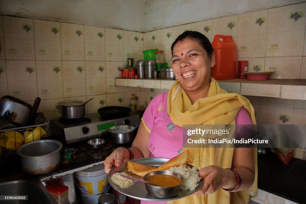 Portrait of a smiling woman offering food