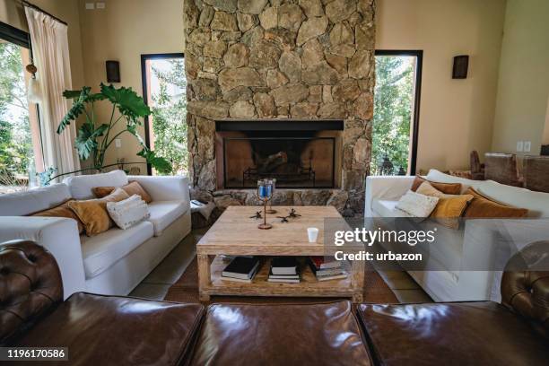 beautiful living room with fireplace - stone fireplaces stock pictures, royalty-free photos & images