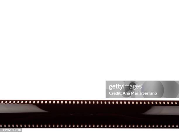 close-up of 35mm photographic film on white background - film camera roll photos et images de collection