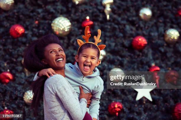 happy mother and daughter celebrating christmas. - reindeer horns stock pictures, royalty-free photos & images