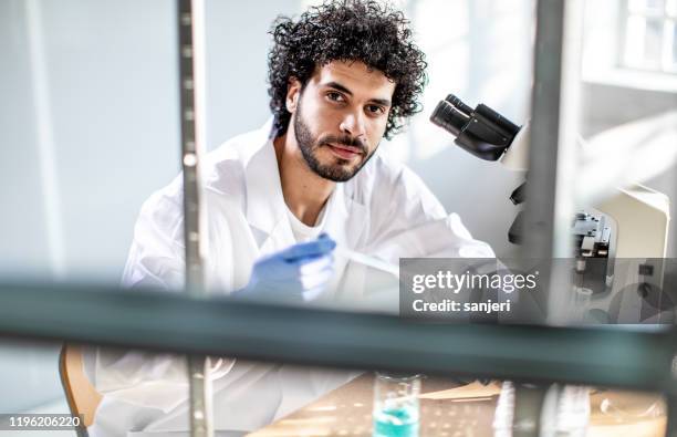 ritratto di scienziato maschio che lavora in laboratorio - scienziato uomo foto e immagini stock