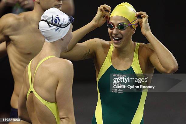 Bronte Barratt and Stephanie Rice of Australia talk on deck during a swimming training session on Day Eight of the 14th FINA World Championships at...