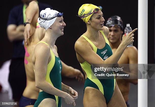 Bronte Barratt and Stephanie Rice of Australia talk on deck during a swimming training session on Day Eight of the 14th FINA World Championships at...