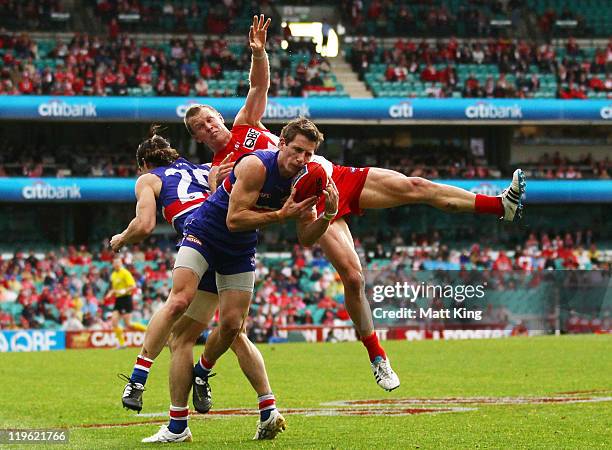 Dale Morris of the Bulldogs takes a mark in front of Ryan O'Keefe of the Swans during the round 18 AFL match between the Sydney Swans and the Western...