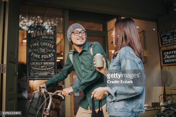 go green with hipster couple at the coffee shop before working - asian coffee at cafe imagens e fotografias de stock