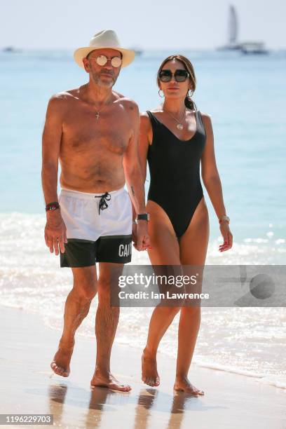 Duncan Bannatyne and Nigora Bannatyne seen walking and swimming in the sea outside Sandy Lane Hotel on December 27, 2019 in Bridgetown, Barbados.