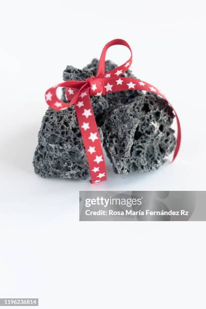 soft coal pieces over white background. typical spanish candy of three wise men day. copy space. - coal foto e immagini stock