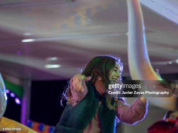 portrait of a little girl's first time at the amusement park ride - mechanical bull stock pictures, royalty-free photos & images