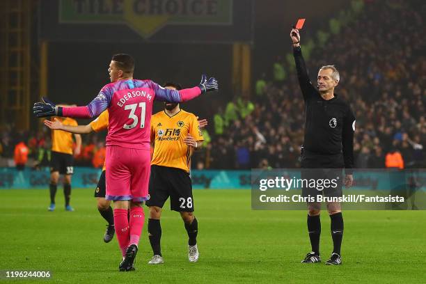 Ederson of Manchester City is sent off by referee Martin Atkinson during the Premier League match between Wolverhampton Wanderers and Manchester City...