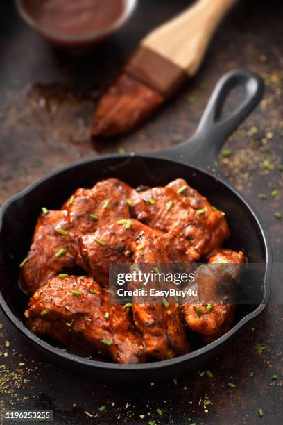 chiken wings in a skillet - barbeque sauce stock pictures, royalty-free photos & images