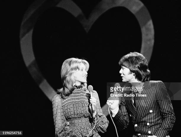Singers Olivia Newton-John and Cliff Richard performing in a BBC television studio, circa 1971.