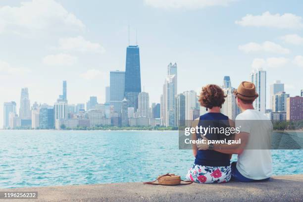 adult couple looking at chicago skyline - seen great lakes stock pictures, royalty-free photos & images