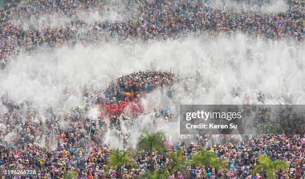 crowd splashing water at each other celebrating water splashing festival, jinghong, xishuangbanna, yunnan province, china - xishuangbanna stock pictures, royalty-free photos & images