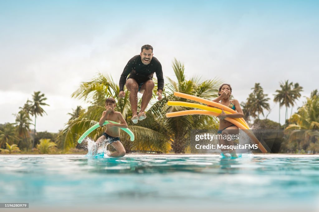 Tourists bathing in resort swimming pool