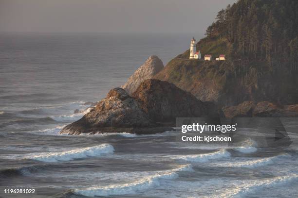 heceta head lightouse and waves at sunset - heceta head stock pictures, royalty-free photos & images