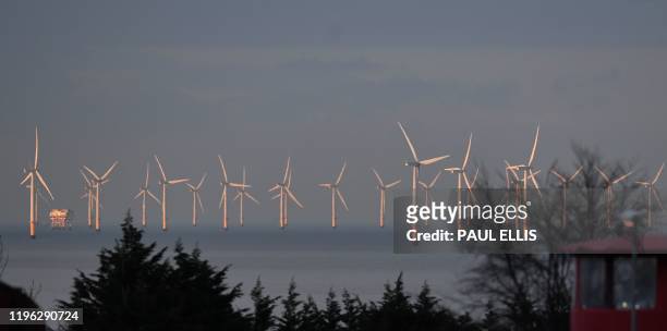 In this file photo taken on March 16, 2018 Wind turbines stand in the Irish Sea at the Gwynt y Mor Offshore Wind Farm, off the coast of Colwyn Bay,...
