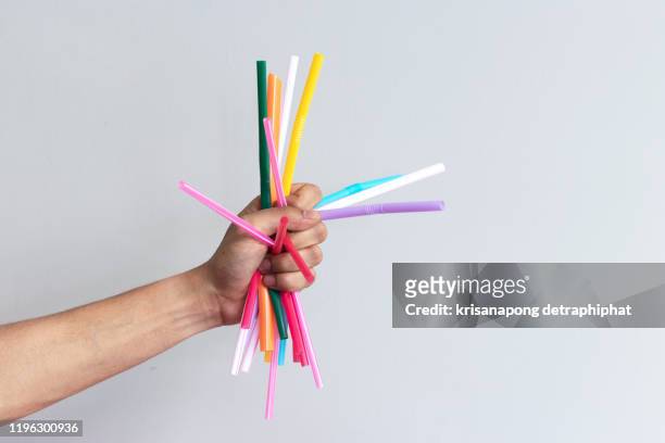 concept of reducing pollution,used plastic straws in recycle bin,waste recycling - drinking straw photos et images de collection