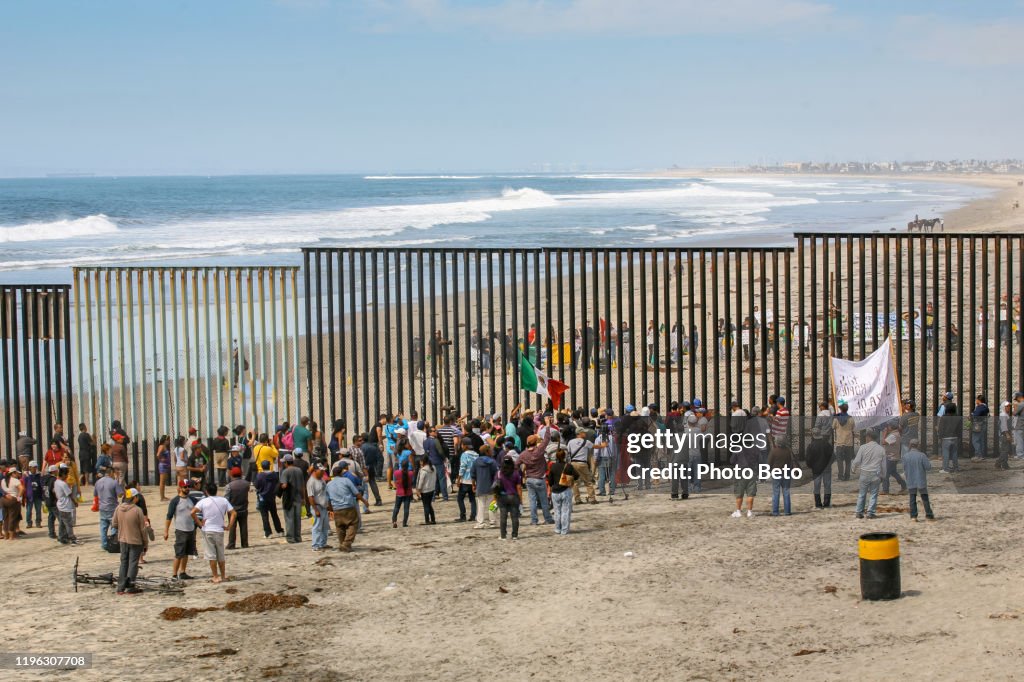 Migrants and workers meet along both sides of the US-Mexico border wall at Tijuana Beach in northern Mexico