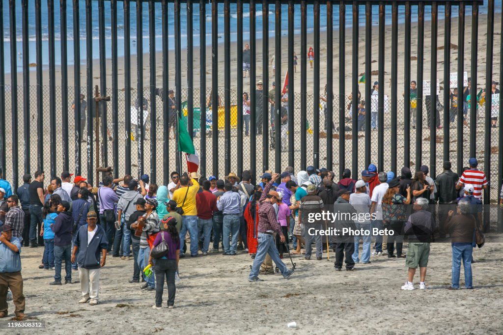 Migrants and workers meet along both sides of the US-Mexico border wall at Tijuana Beach in northern Mexico