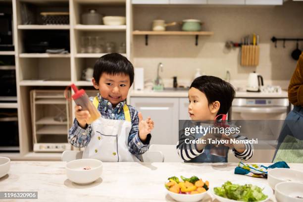 good brothers mixing dressing - children cooking school stock-fotos und bilder