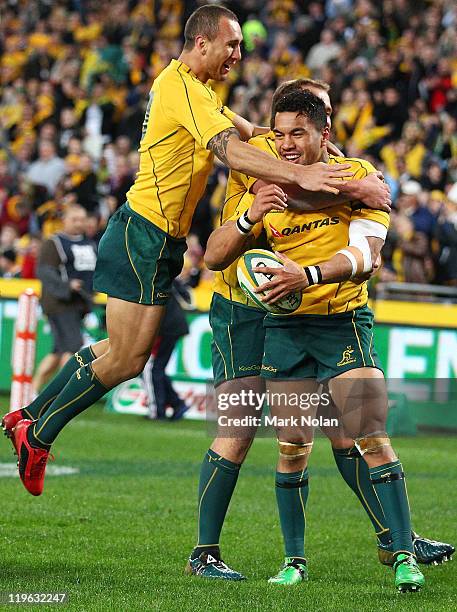 Digby Ioane of the Wallabies is congratulated by Quade Cooper after scoring during the Tri-Nations match between the Australian Wallabies and the...