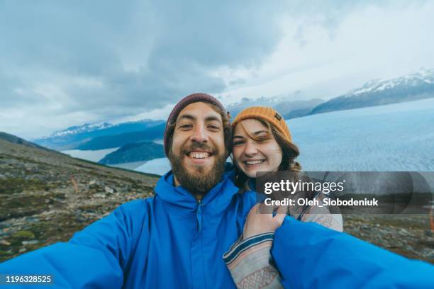 selfie of couple on the background of  grey glacier in torres del paine national park - torres del paine national park imagens e fotografias de stock