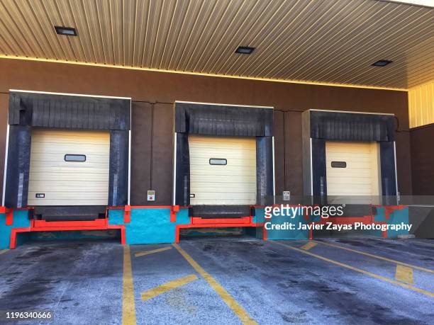 three closed doors of warehouse loading dock - roller shutter 個照片及圖片檔