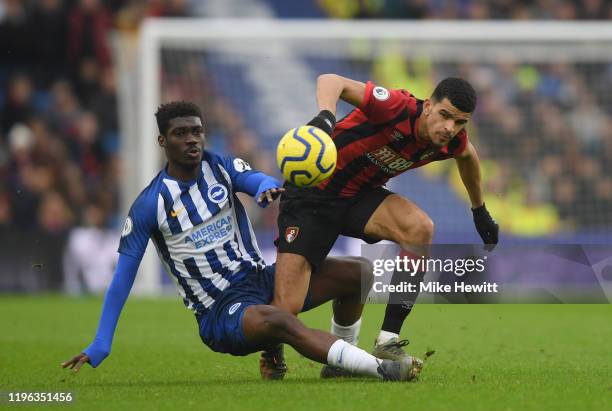 Dominic Solanke of AFC Bournemouth is tackled by Yves Bissouma of Brighton & Hove Albion during the Premier League match between Brighton & Hove...