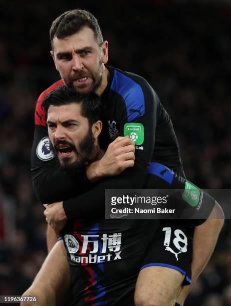 James Tomkins of Crystal Palace celebrates with teammate James McArthur after scoring his team's first goal during the Premier League match between...