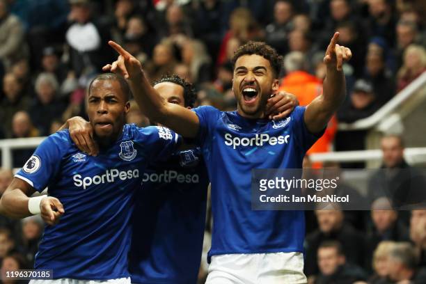 Dominic Calvert-Lewin of Everton celebrates with teammates Djibril Sidibe and Theo Walcott after scoring his team's second goal during the Premier...