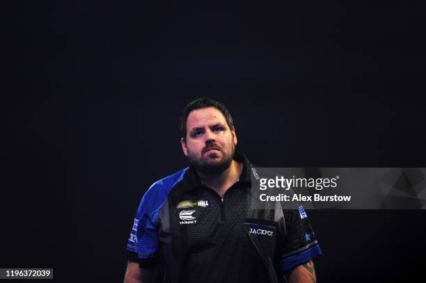 Adrian Lewis of England reacts as he walks off the stage after loosing his Fourth Round match against Dimitri Van den Bergh of Belgium during Day...