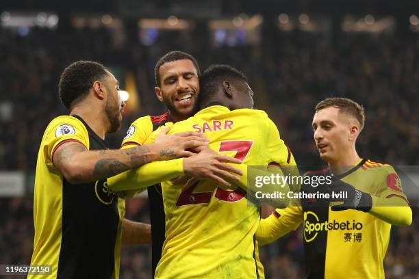 Ismaila Sarr of Watford celebrates after scoring his sides third goal with teammates during the Premier League match between Watford FC and Aston...