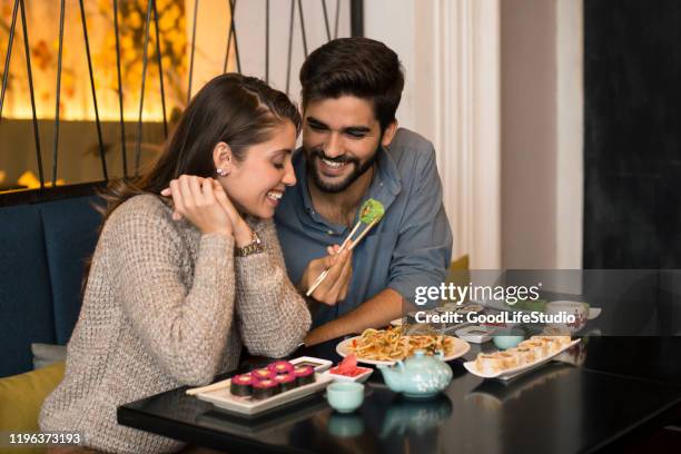 couple eating sushi - sushi stock pictures, royalty-free photos & images