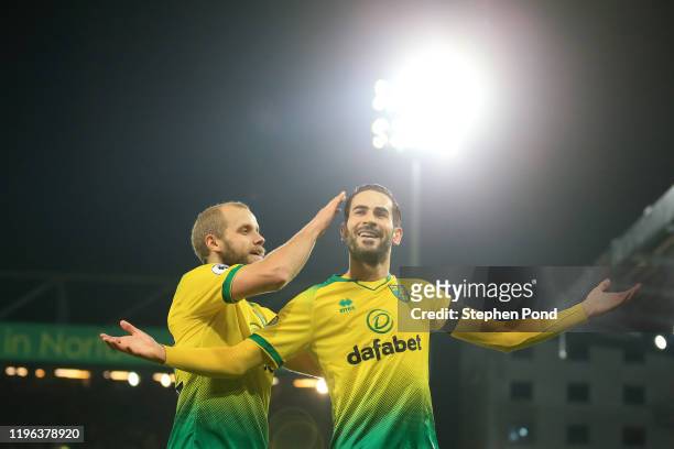 Mario Vrancic of Norwich City celebrates with teammate Teemu Pukki of Norwich City after scoring his team's first goal during the Premier League...