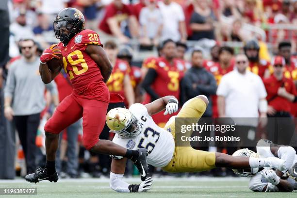 Breece Hall of the Iowa State Cyclones runs with the ball after breaking a tackle against Khalid Kareem of the Notre Dame Fighting Irish in the first...