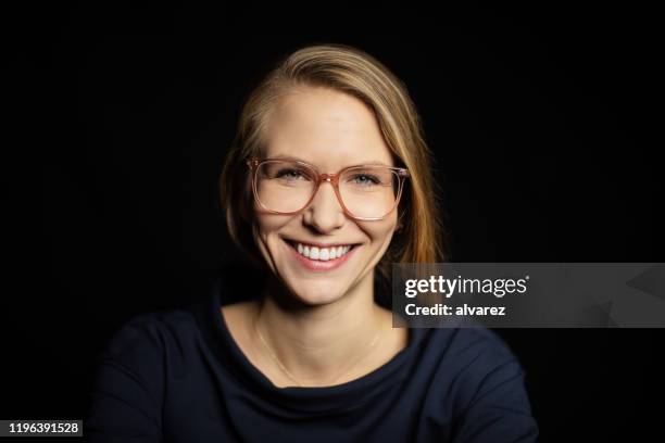 portrait of beautiful young woman smiling - blonde hair black background stock pictures, royalty-free photos & images