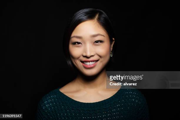 portrait of asian woman looking confident - black backgrounds stock pictures, royalty-free photos & images