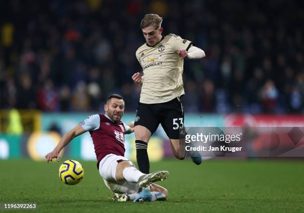 Brandon Williams of Manchester United is tackled by Phil Bardsley of Burnley FC during the Premier League match between Burnley FC and Manchester...