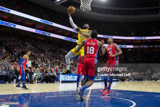 LeBron James of the Los Angeles Lakers scores a basket against Shake Milton and Al Horford of the Philadelphia 76ers in the third quarter at the...