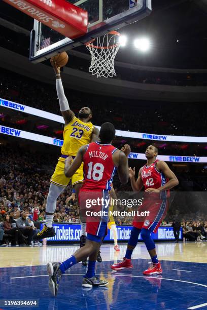 LeBron James of the Los Angeles Lakers scores a basket against Shake Milton and Al Horford of the Philadelphia 76ers in the third quarter at the...