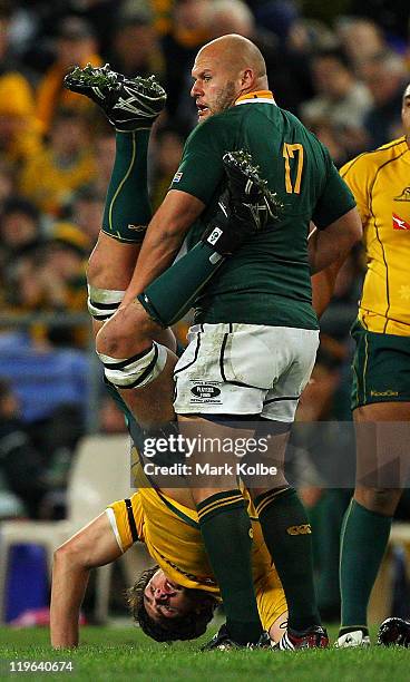 Rob Simmons of the Wallabies is held upside down by CJ van der Linde of the Springboks during the Tri-Nations match between the Australian Wallabies...