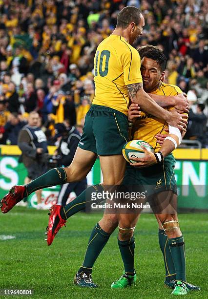 Digby Ioane of the Wallabies is congratulated by Quade Cooper after scoring during the Tri-Nations match between the Australian Wallabies and the...